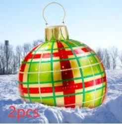 Large red and white striped inflatable Christmas ball ornament hanging on an outdoor tree