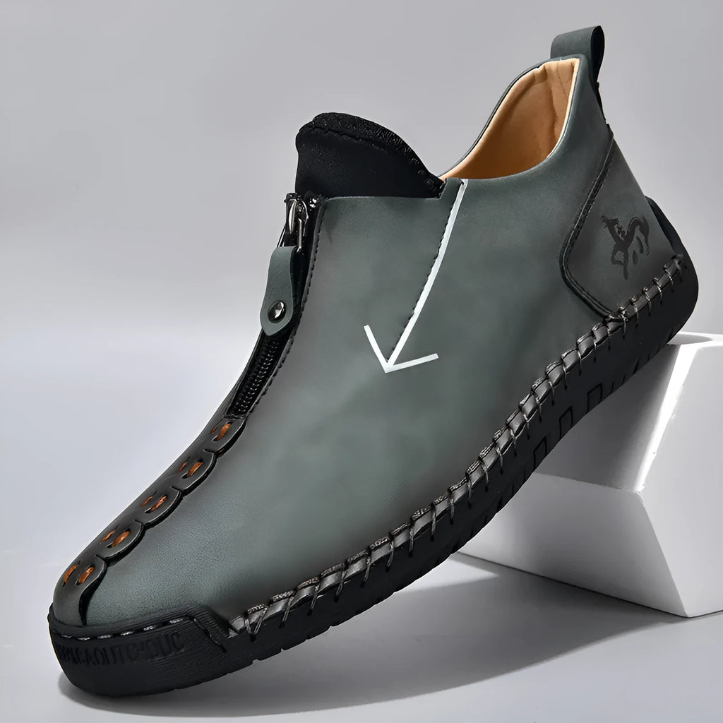 Men's black leather martin boots with a front zip, round toe, and hand-stitched seams on a rubber sole.
