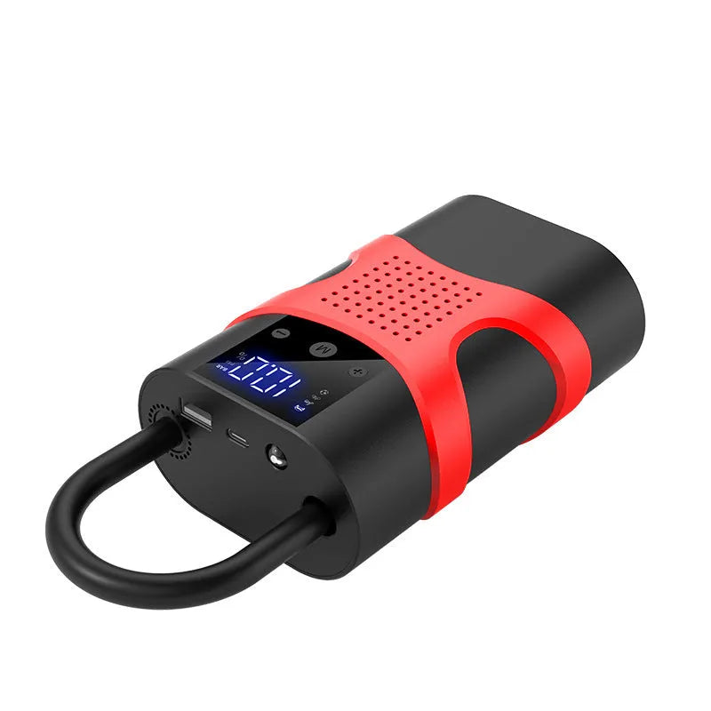 Portable car emergency jump starter with digital display air pump on a dark background