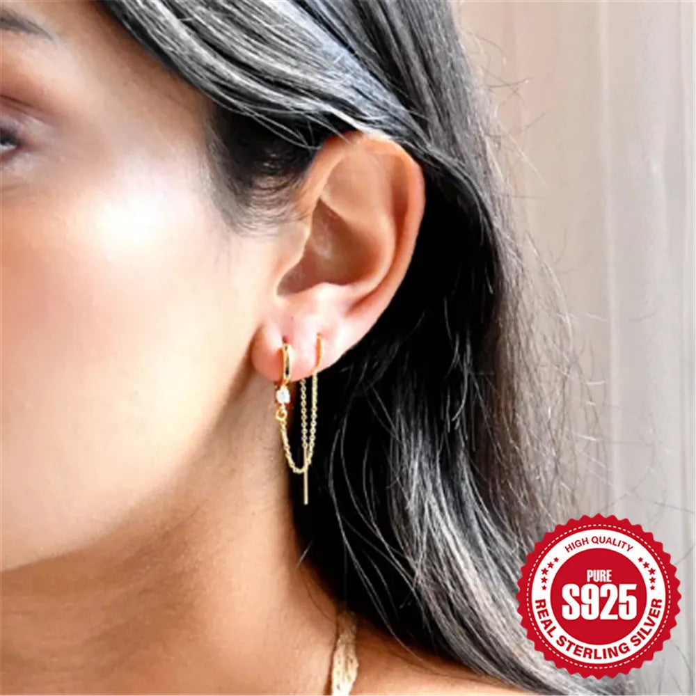 Golden S925 sterling silver stud earrings with a geometric diamond flower and delicate tassel chain design.