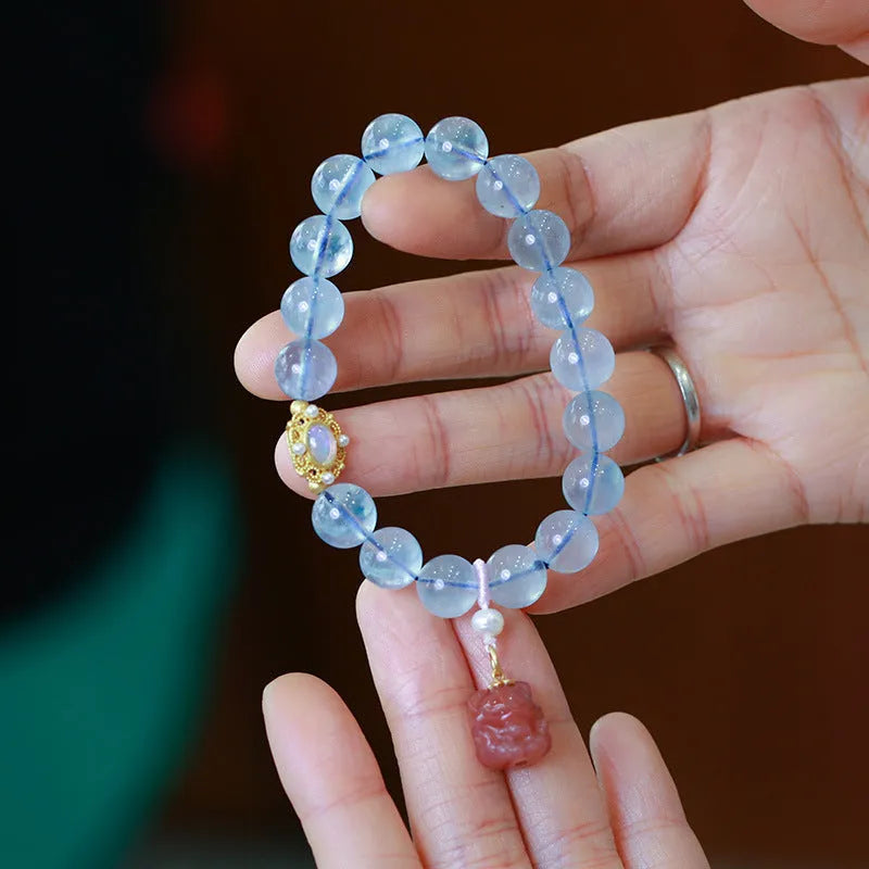 Aquamarine gemstone and components for a DIY Fengjiu Chinese style bracelet kit for women.