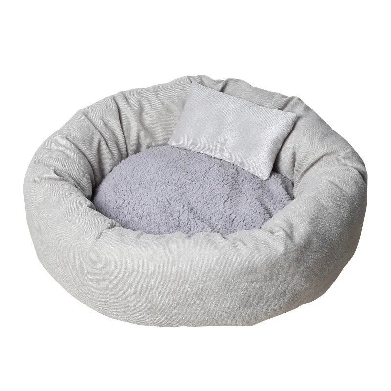 Light grey cotton-filled dog bed showing rounded shape and soft padding, with optional pillow beside it