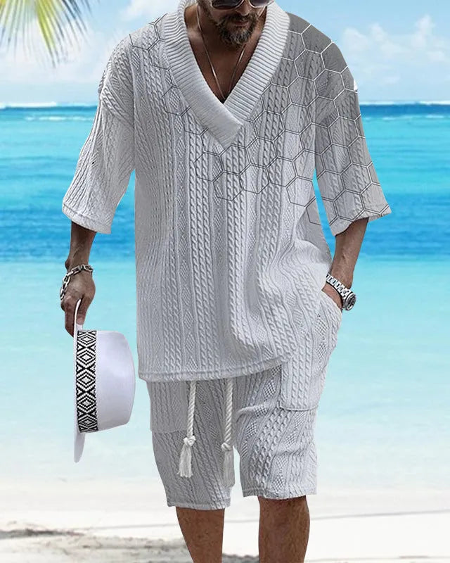 Man wearing a printed drop-shoulder knitted short-sleeve jacket with matching shorts in a casual setting.