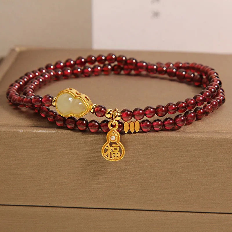Chinese style gourd bracelet with imitation garnet stones and cultural motifs including Fu character design