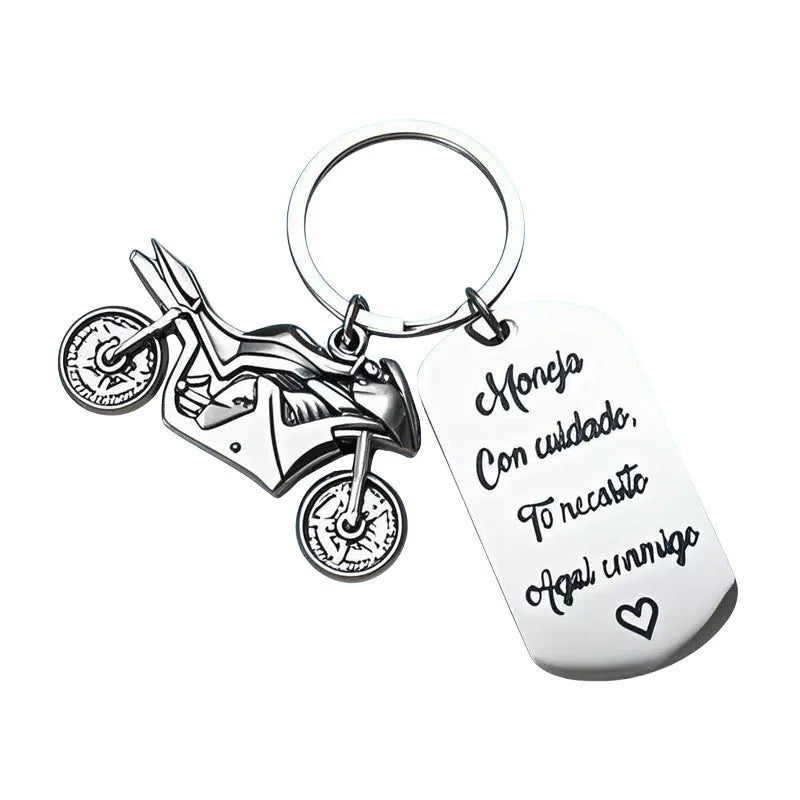 Stainless steel motorcycle-themed keychain on a velvet flannel bag