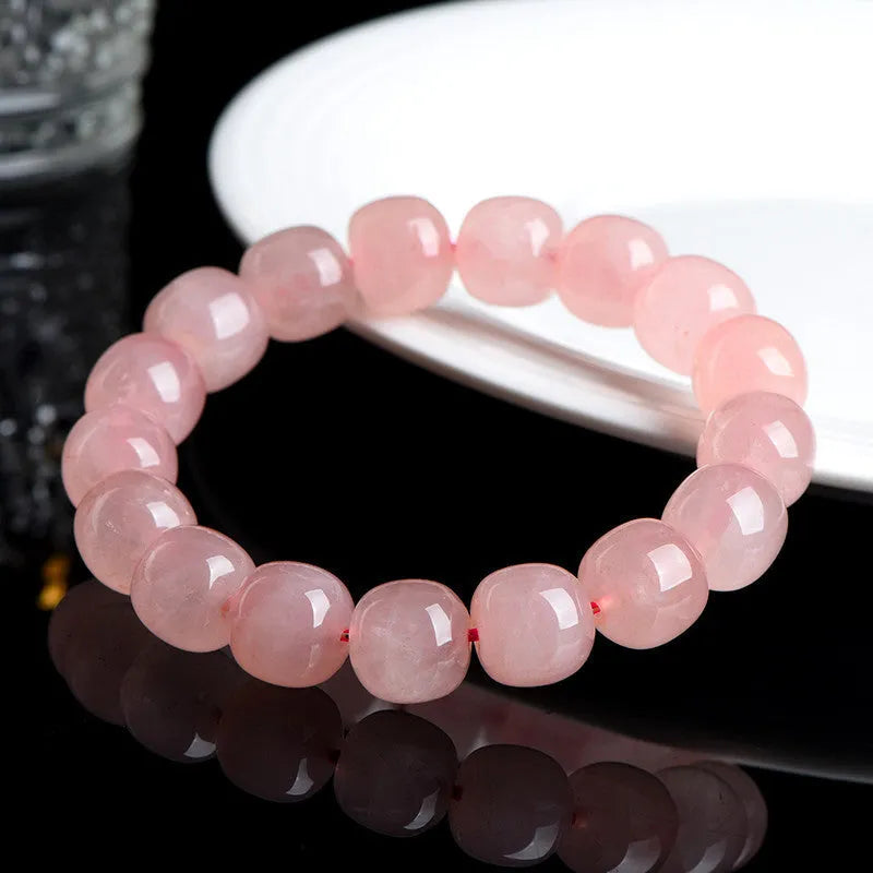 Natural pink crystal barrel bead bracelet with geometric design and polished finish