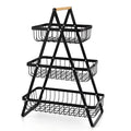 Black detachable iron double-layer fruit basket with wooden handle on tabletop
