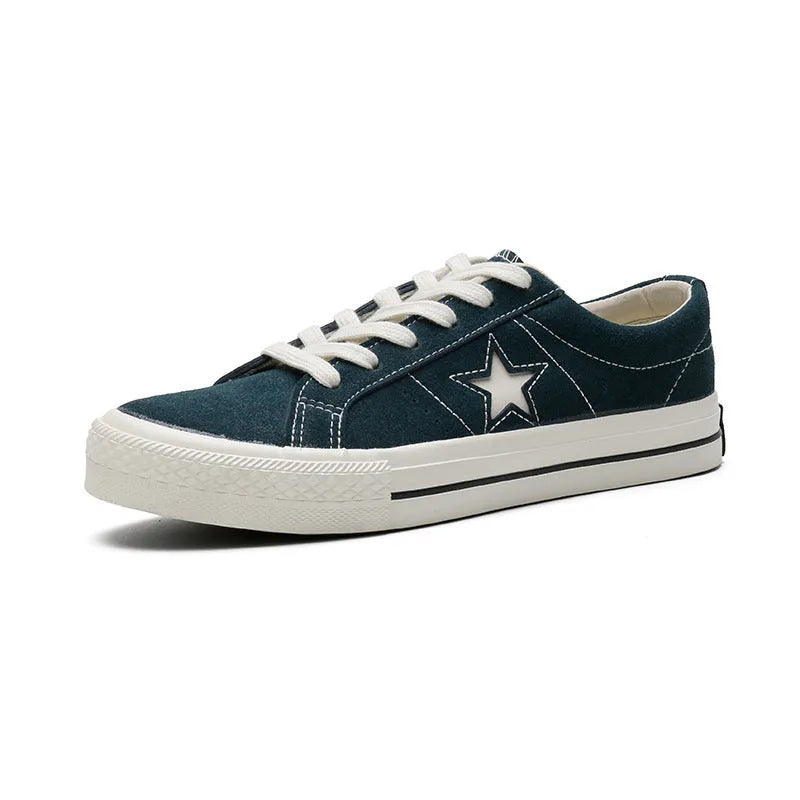 Low top board shoes with cross straps and leather stitching, available in green, black, light blue, grey, ink blue