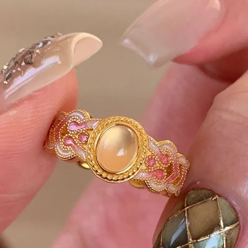 Geometric open-mouth ring with pink crystal enamel decoration on gold-plated copper band
