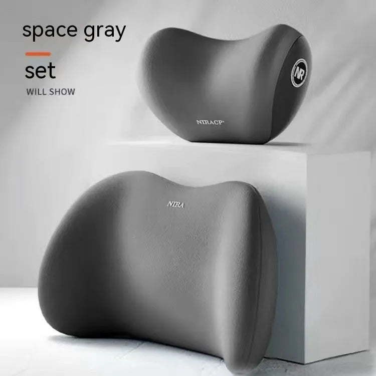 Black memory foam car lumbar support pillow and matching headrest pillow on a car seat.