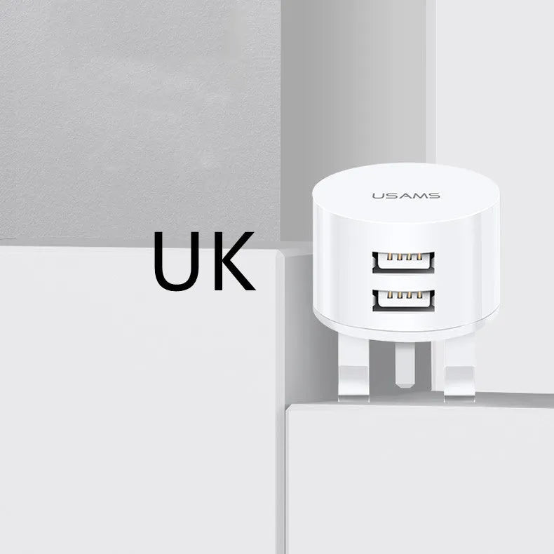 White portable universal dual USB phone charger showing US, EU and UK plug compatibility