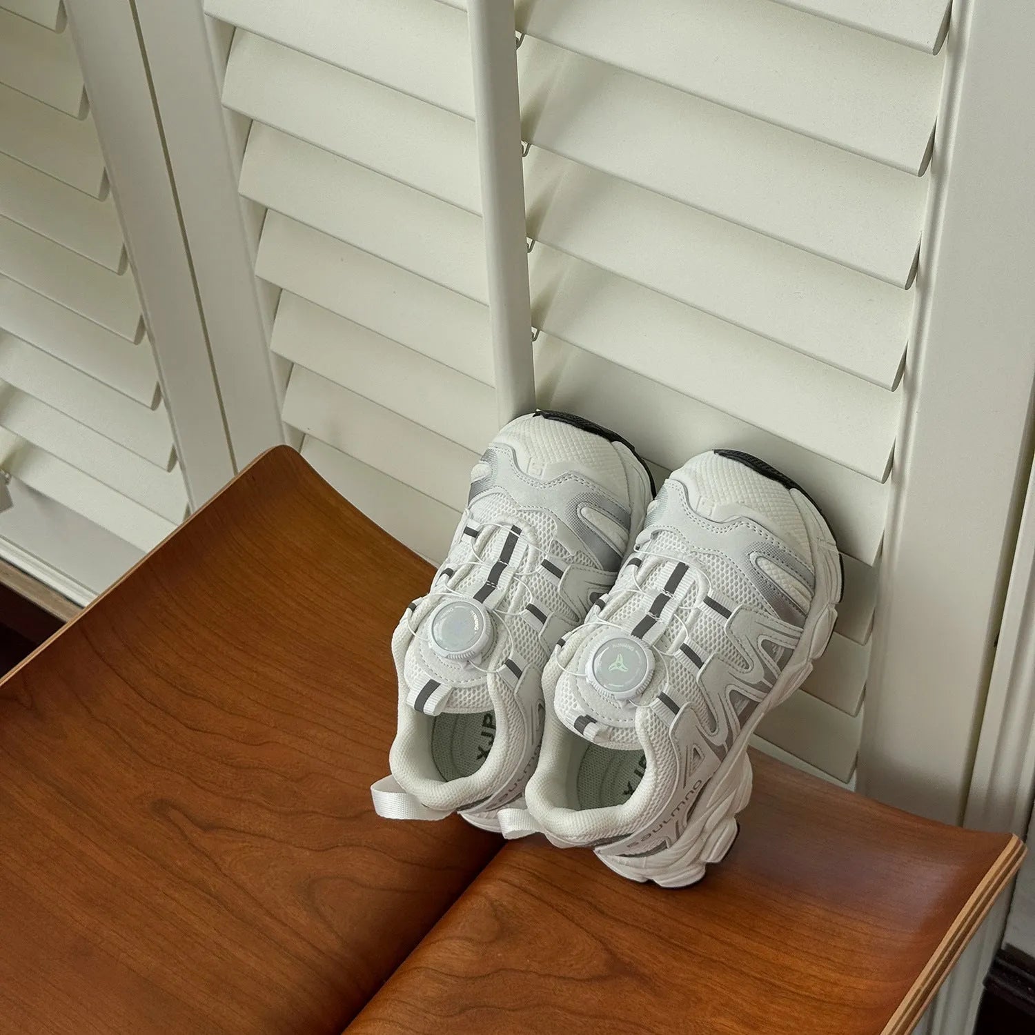 Girls solid colour casual slip-on sneakers in beige, made from lightweight PU leather mesh.