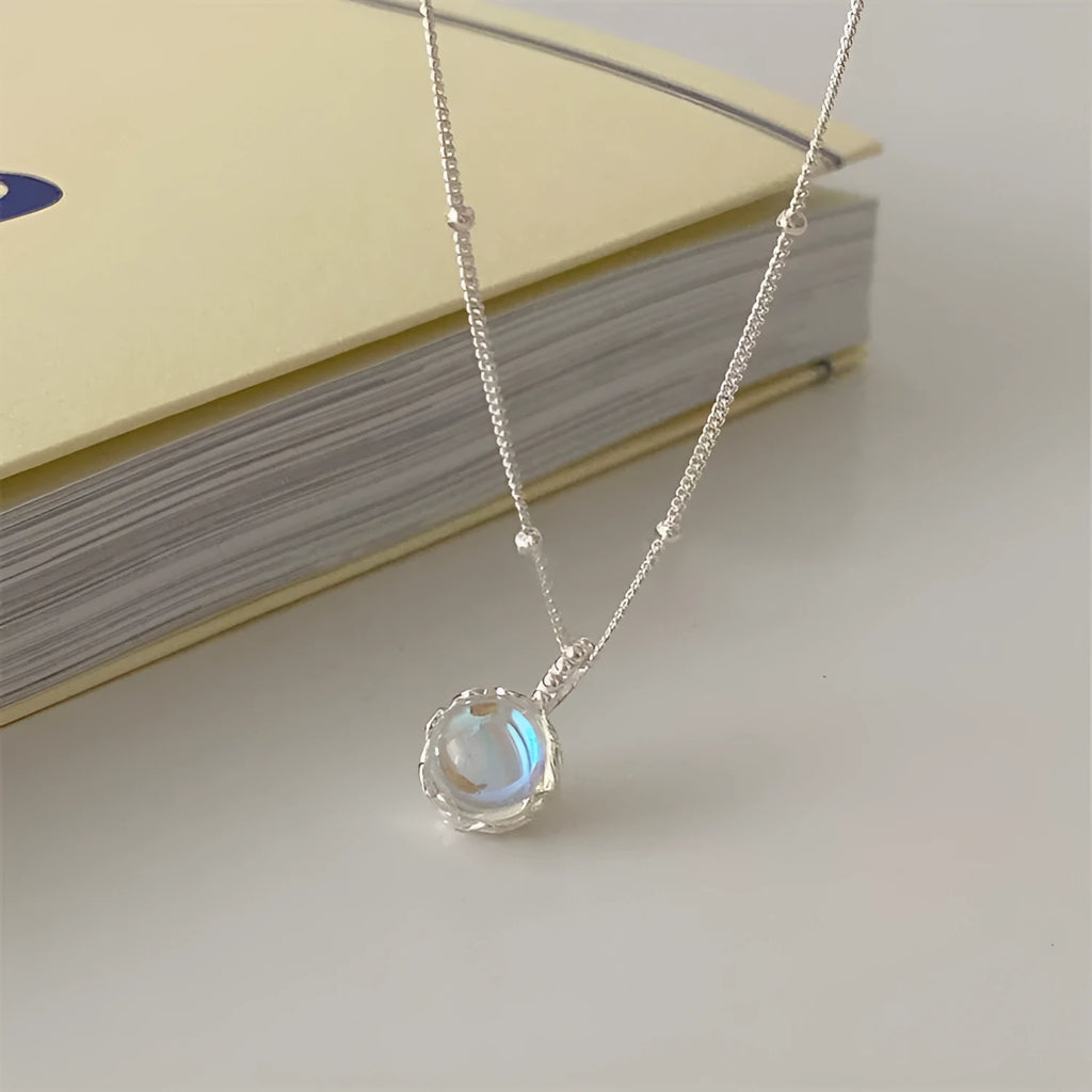 Silver geometric pendant on an adjustable curb chain necklace.