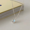 Silver geometric pendant on an adjustable curb chain necklace.