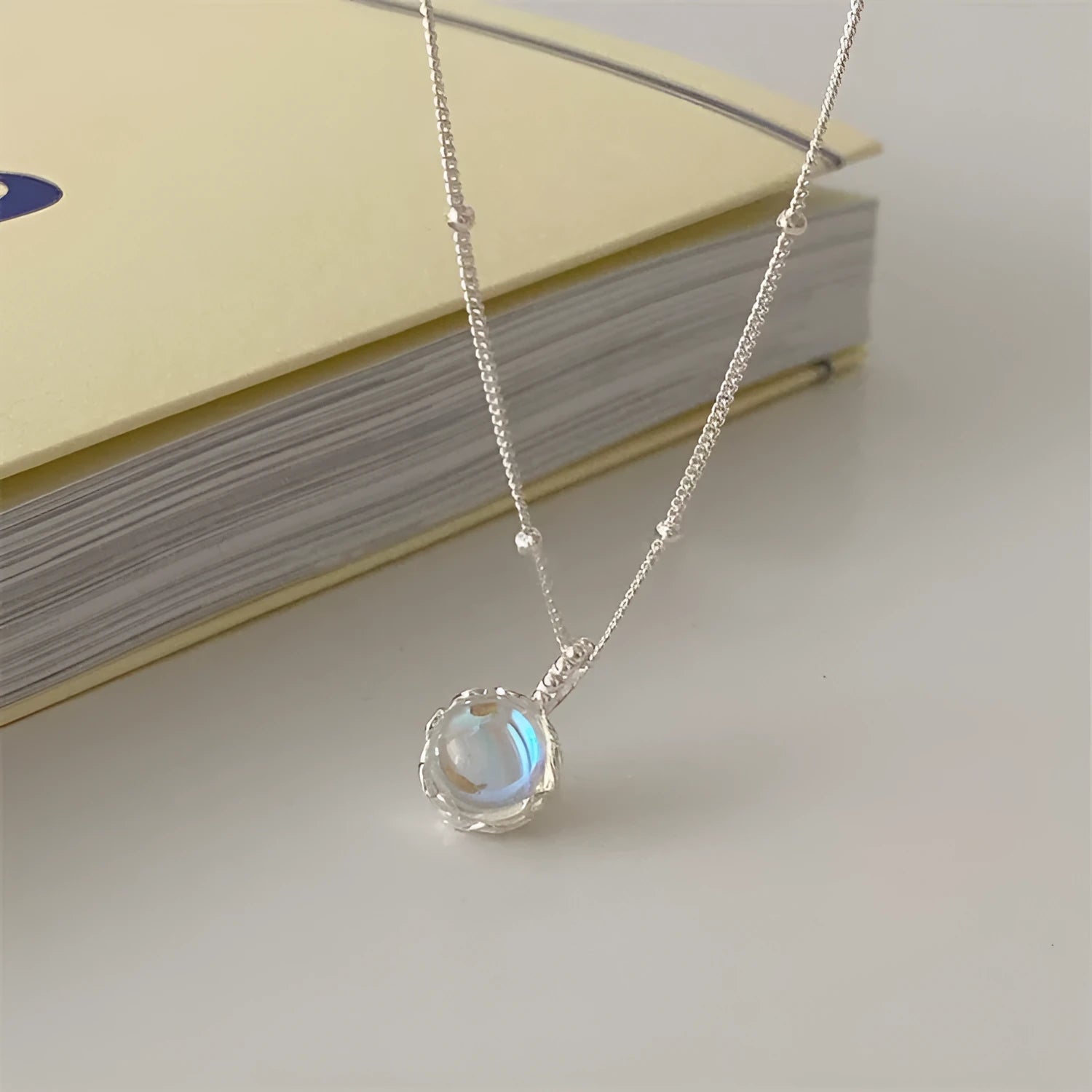 Silver geometric pendant on an adjustable curb chain necklace.