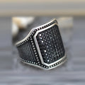 Black alloy ring with copper inlaid zircon detailing showing metallic finish