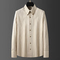 Coffee coloured striped men's long-sleeved shirt with slim fit on a hanger.