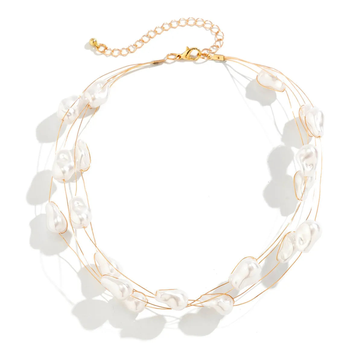 Gold-tone baroque imitation pearl necklace and bracelet set with U-shaped pendant on woman