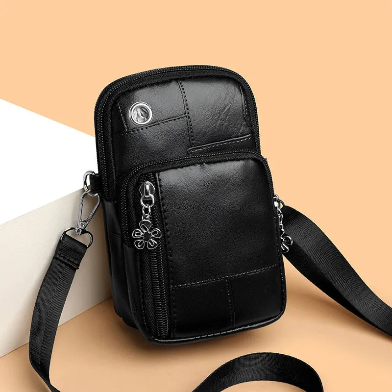 Square vertical mini mobile phone bag in PU leather, shown in water blue colour with a front sandwich pocket.
