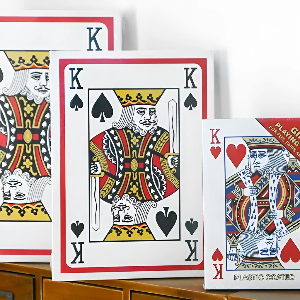 Set of oversized large size paper playing cards laid out on a table, showing the full 54-sheet deck.