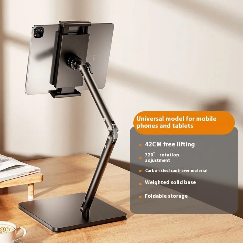 Silver alloy desktop phone and tablet bracket with double adjustable arms and a remote control on a wooden desk.