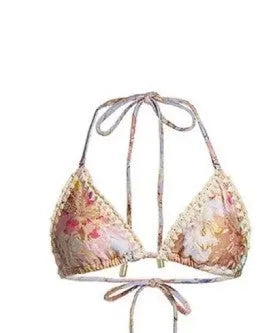 Women's creamy white floral bikini set with halter top, high-waisted briefs and matching skirt