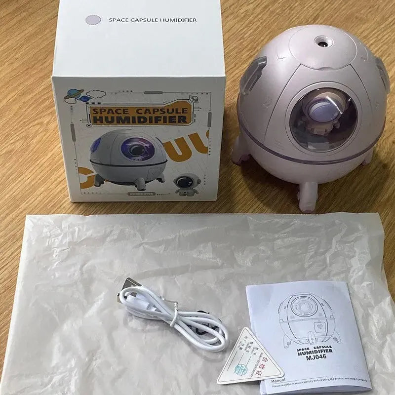 Light purple astronaut-shaped USB desktop humidifier with LED light on a desk