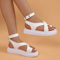 Women's black Roman sandals with buckle fastening and thick composite sole