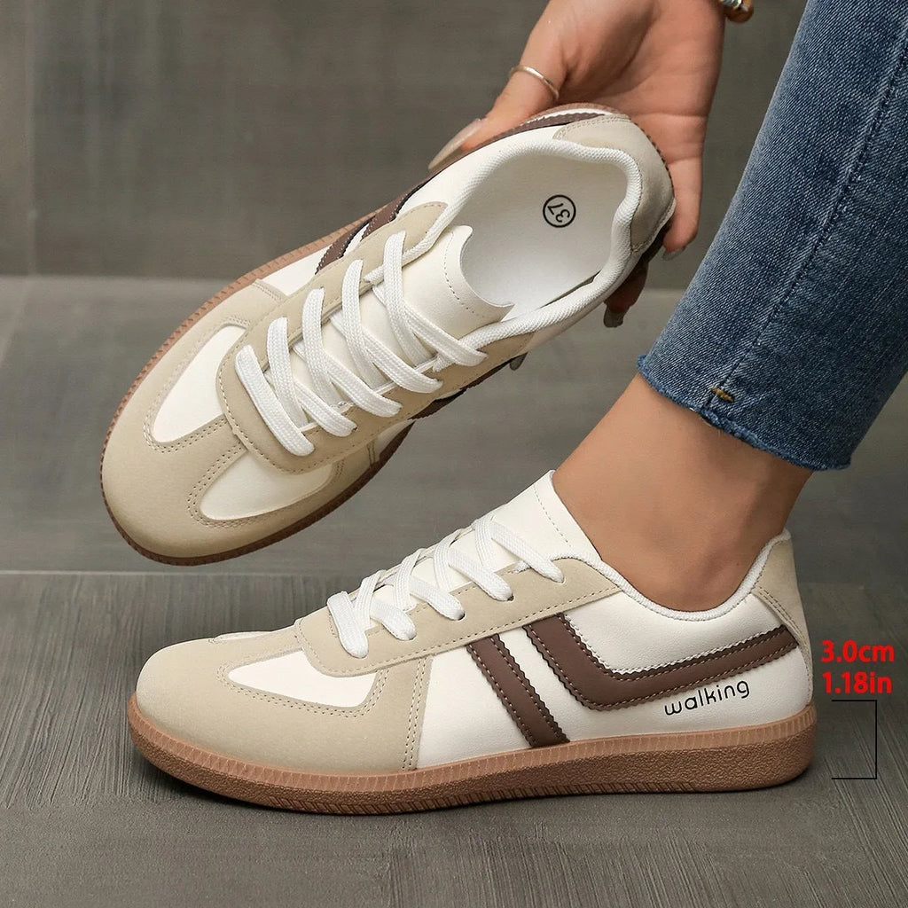 A pair of retro-style low-top lace-up sneakers in a selected colour on a plain background.