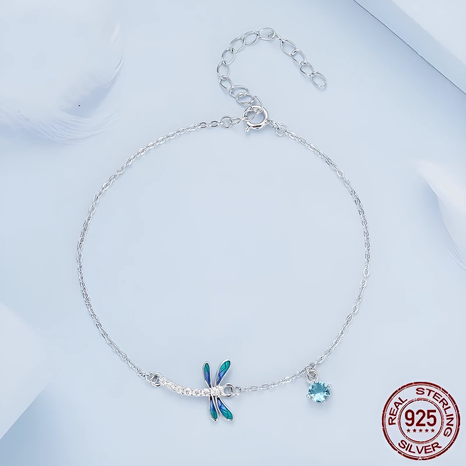 Sterling silver white gold plated dragonfly bracelet with dripping zircon stones on white background