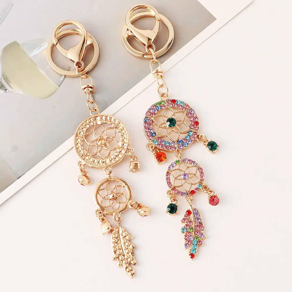 Creative diamond studded flower shaped car keychain dream catcher in pink alloy light luxury style on white background