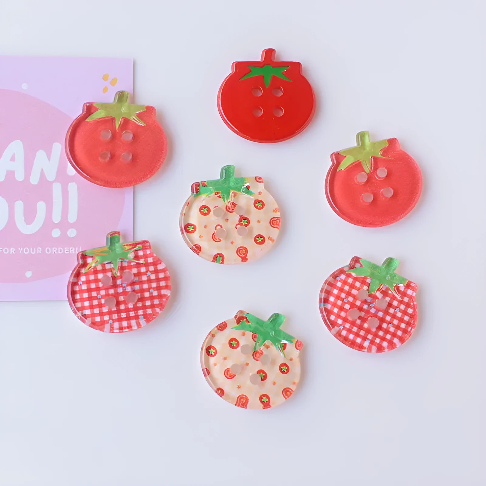 Plastic tomato button ornaments in cherry tomato printing, red plaid, solid red, and mixed colour designs
