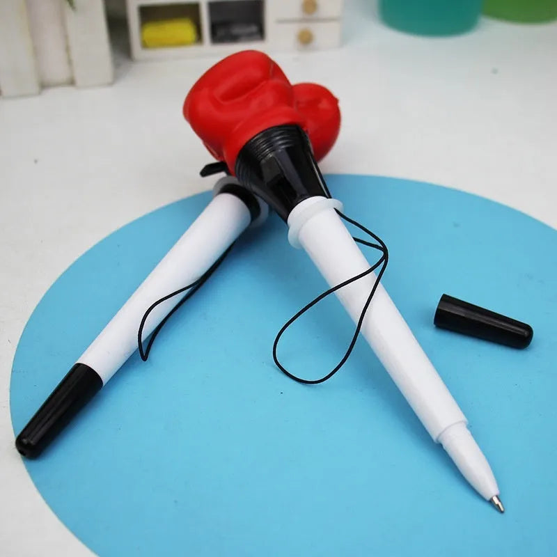 Four black pressure relief boxing press ejection pens with plug-in sleeve mechanisms on a desk.