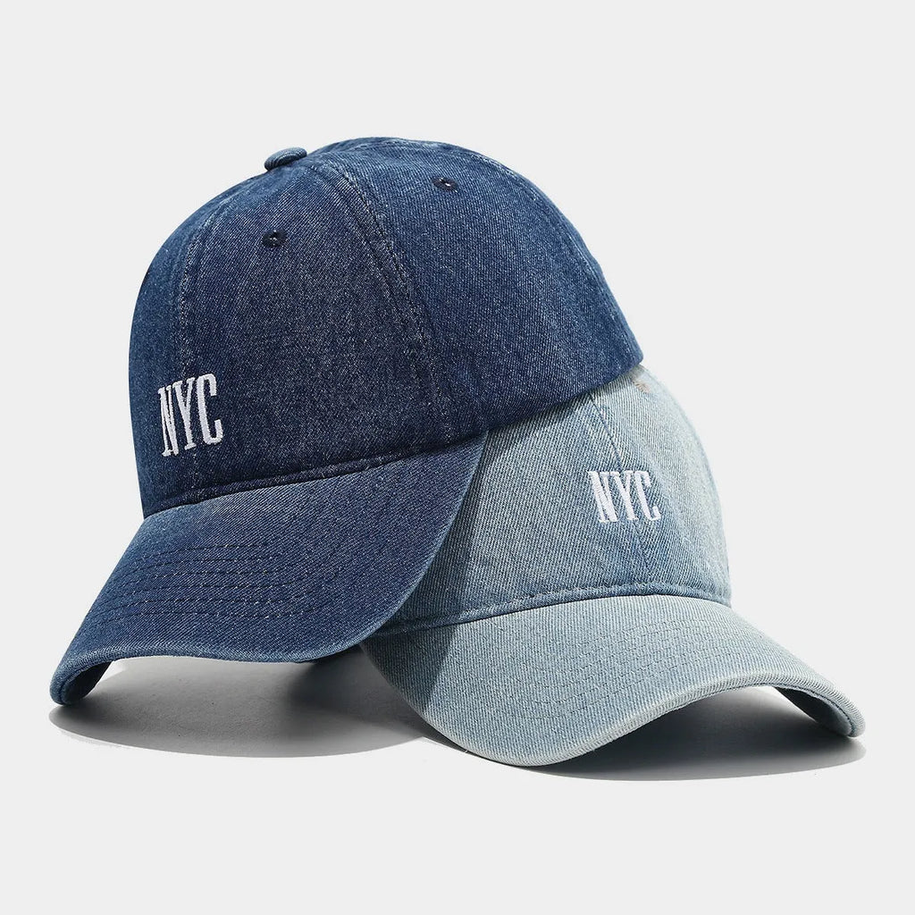 Retro denim peaked cap with embroidered letters on the front, shown in an adjustable size.