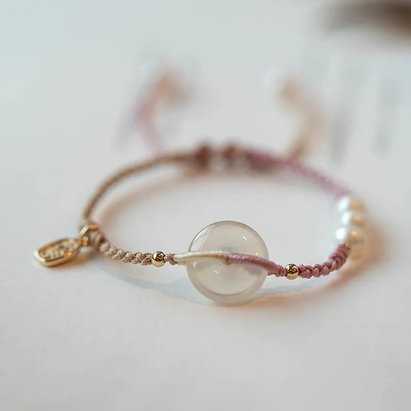 Crystal bracelet with woven rope strap and geometric square grain detailing in ethnic style
