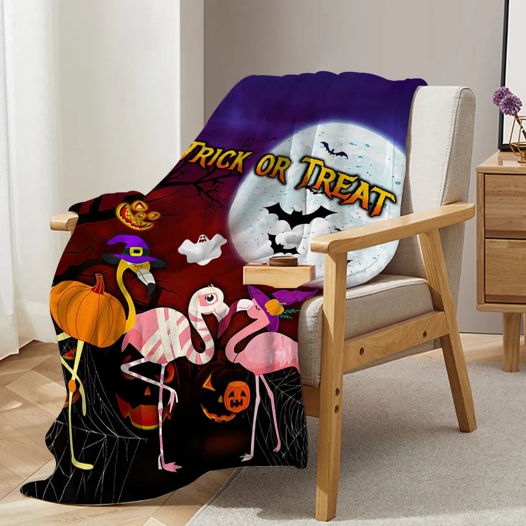 Purple flannel Halloween flamingo printed blanket on a sofa, size 130x150cm