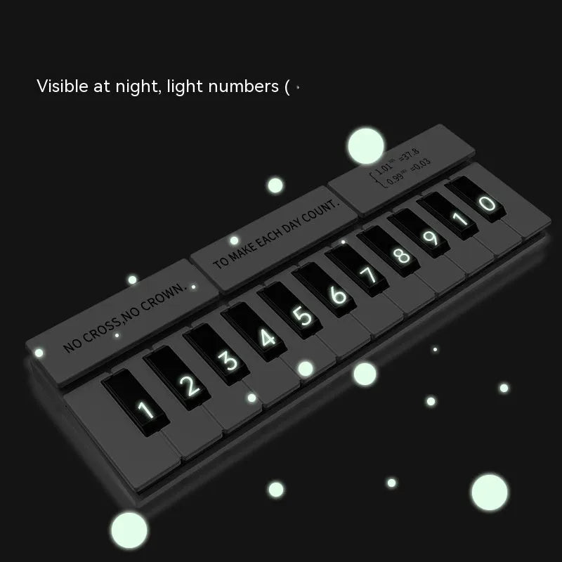 Black and white plastic piano temporary parking sign for car dashboard.