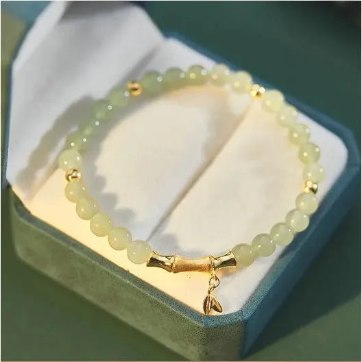 Retro style bamboo bracelet with coloured glass floral beads and ruyi design