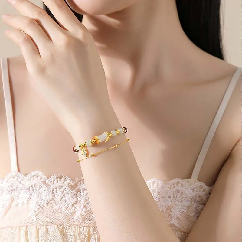 Retro style bamboo bracelet with coloured glass floral beads and ruyi design