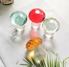 Colourful transparent crystal mushroom decoration on a white background.