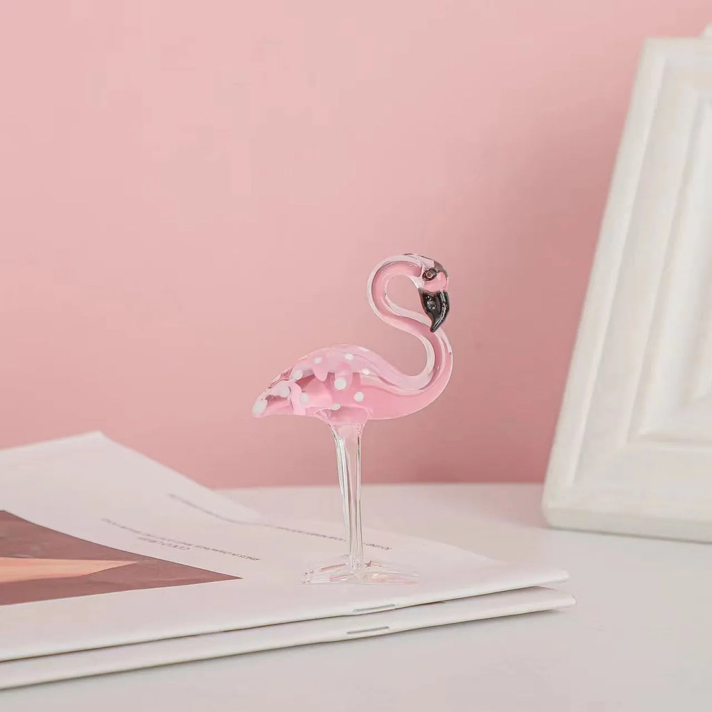 Pink and white crystal flamingo decorative ornament on a table, showing modern simple style.
