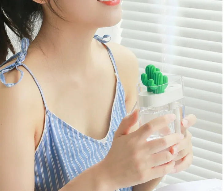 Transparent green cactus-shaped portable USB humidifier on a desk, 120mm tall