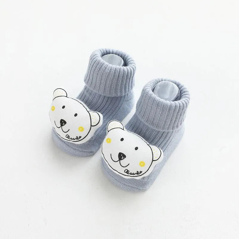 Baby socks with non-slip rubber grip soles on the feet, shown in a light grey colour.