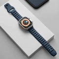 Fluoro rubber watch strap for Apple Watch with T buckle in multiple colour options on a grey background.