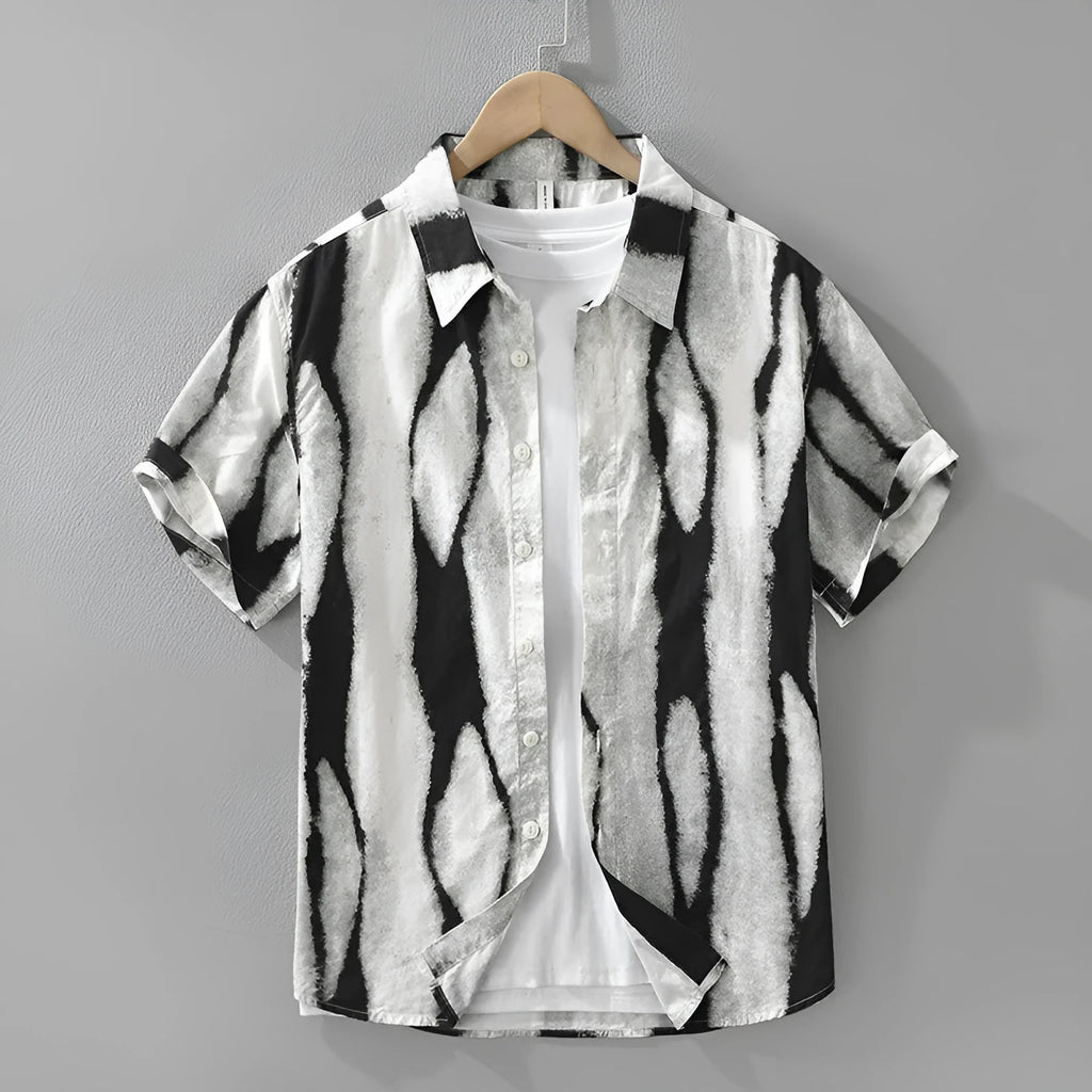 Man wearing a black and white striped retro-style short sleeve cotton shirt with a loose fit.
