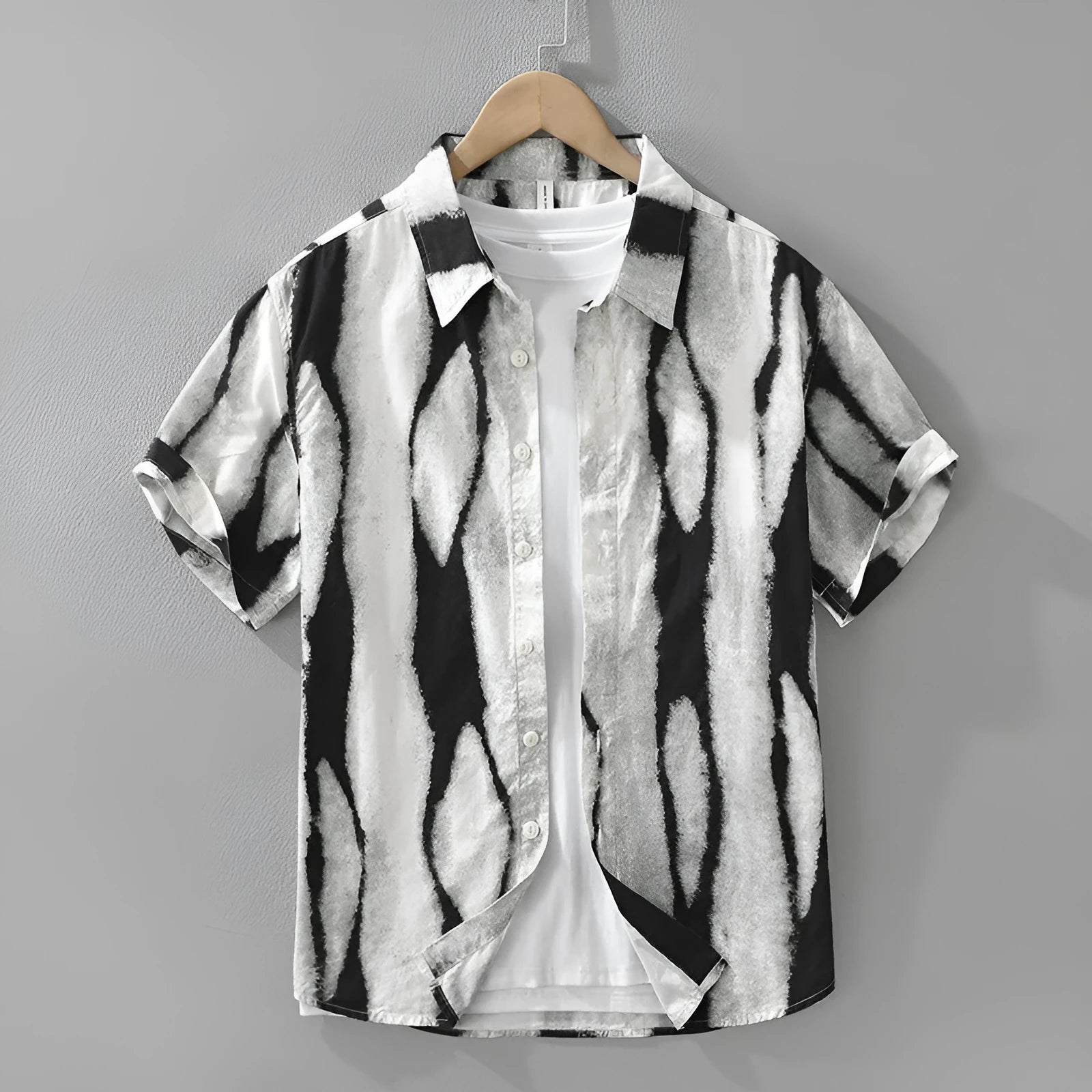 Man wearing a black and white striped retro-style short sleeve cotton shirt with a loose fit.