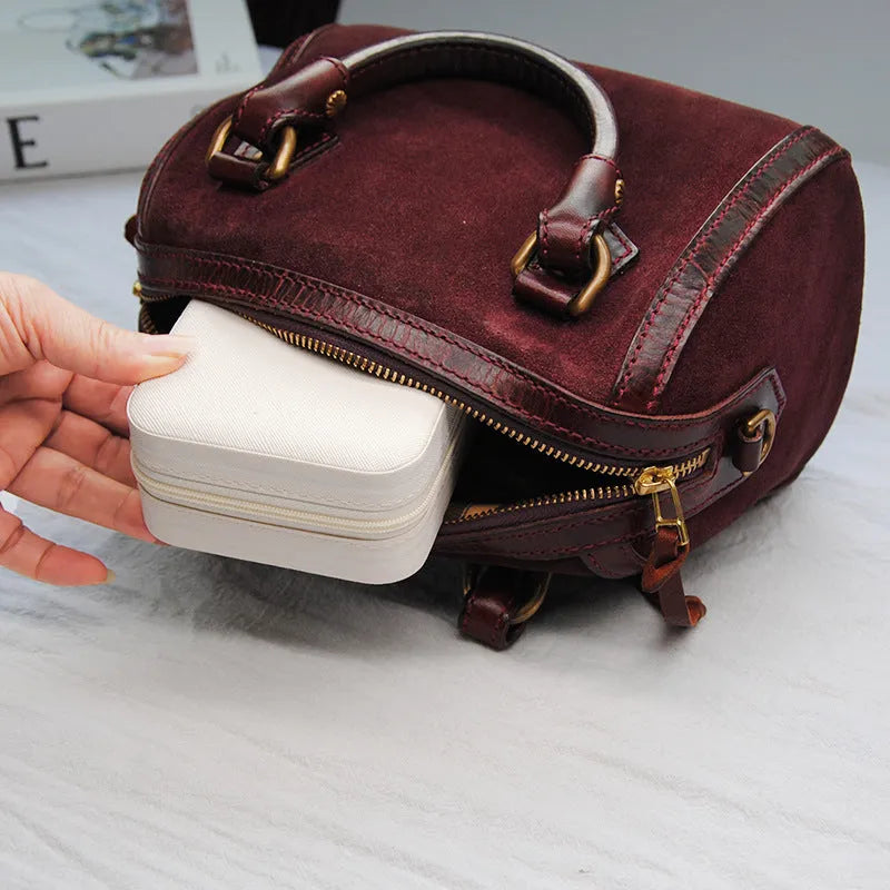 Small leather jewellery box in cross pattern, 10cm size, for earrings and rings, on a flat surface.