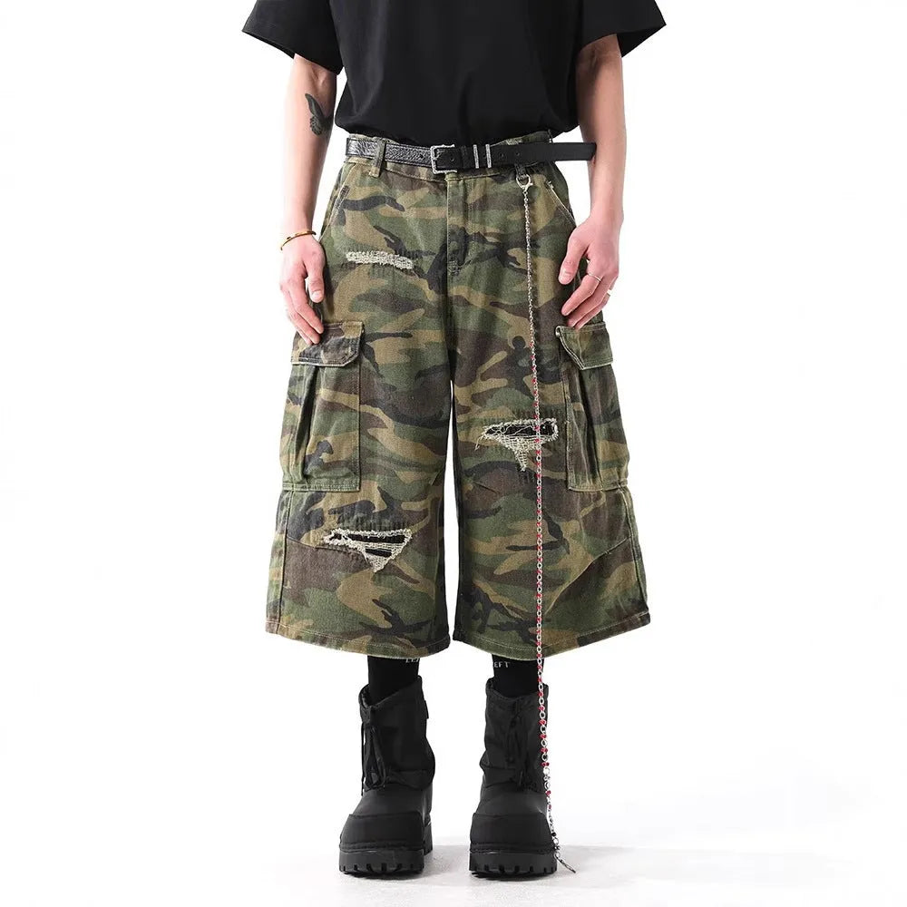 Men's straight-leg cropped trousers in a green and brown camouflage pattern, made from cotton denim.