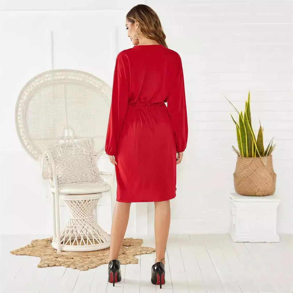 Women's black A-line mid-length dress with long sleeves, elastic cuffs, and an elastic waist belt.