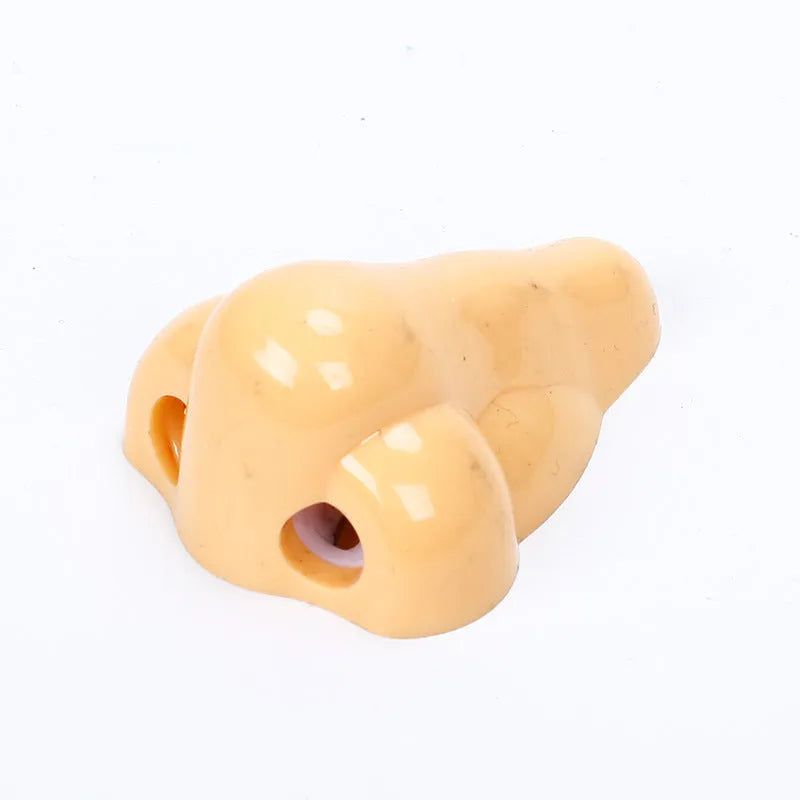 Flesh coloured plastic manual pencil sharpener with geometry shape and large nostril opening
